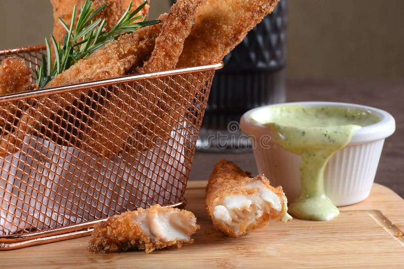 Portion of Fried Fish, Fried Chicken Strips Inside Metal Basket Tasty