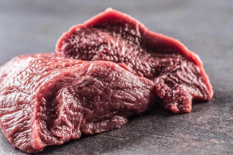 Portion of Raw Beef Shoulder on Dark Butcher Board Stock Photo Image