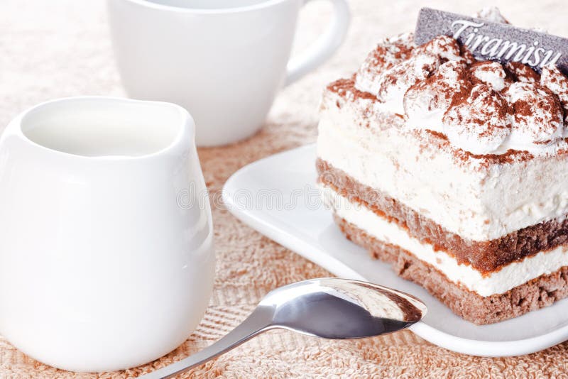 Portion of tiramisu dessert and a cup of coffee