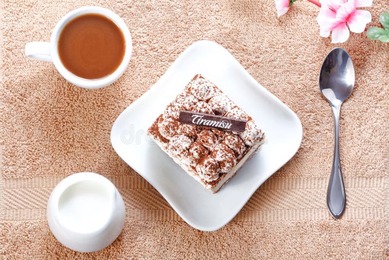 Portion of tiramisu dessert and a cup of coffee