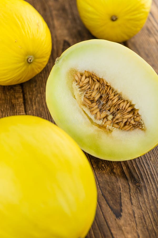 Portion of Yellow Honeydew Melon on Wooden Background Selective Stock
