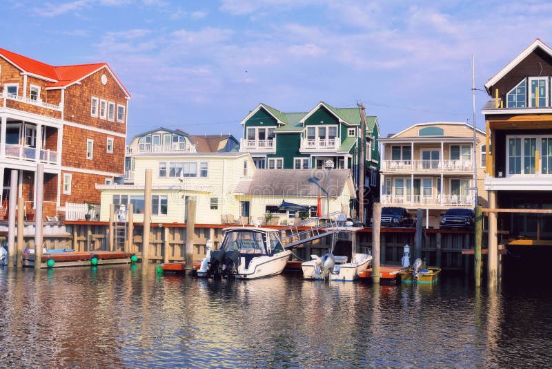 Marinas and houses with red and green roofs reflected in the water. spring time in Cape May NJ. Marinas and houses with red and green roofs reflected in the water. spring time in Cape May NJ