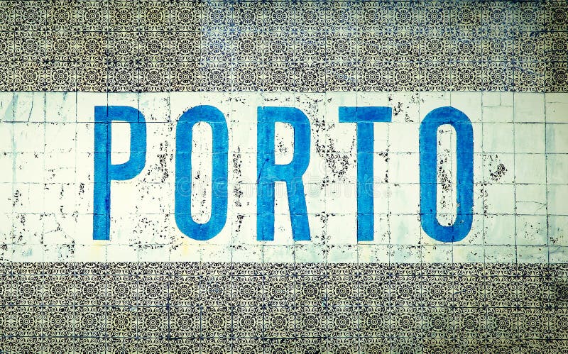 `Porto` written in blue letters over traditional Portuguese old tiles `azulejos` in the city of Porto, Portugal, famous for the Porto Wine `Vinho Do Porto`. `Porto` written in blue letters over traditional Portuguese old tiles `azulejos` in the city of Porto, Portugal, famous for the Porto Wine `Vinho Do Porto`