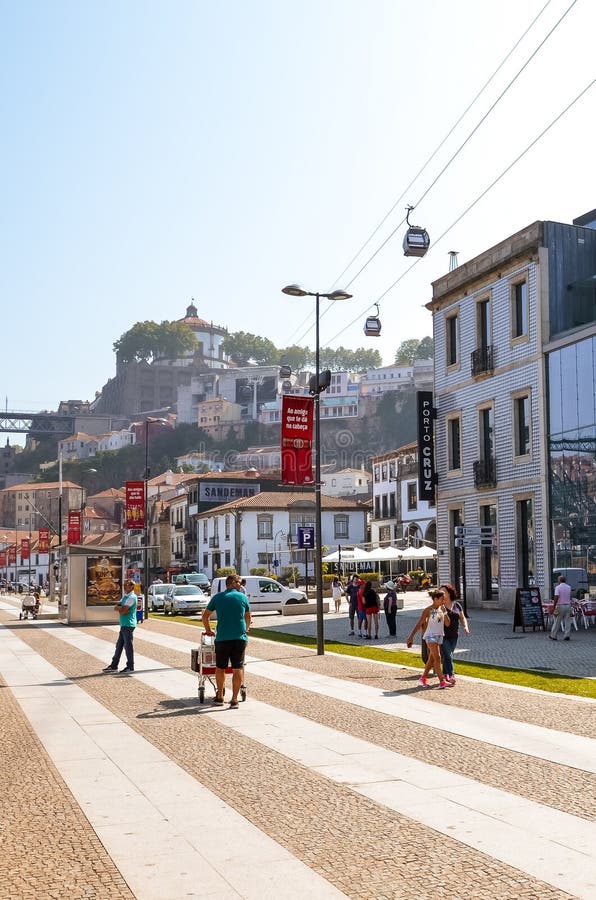 Porto, Portugal - August 31 2018: Tourists walking on promenade by river Douro on a sunny day. The embankment is full of royalty free stock photos Porto, Portugal - August 31 2018: Tourists walking on promenade by river Douro on a sunny day. The embankment is full of royalty free stock photos