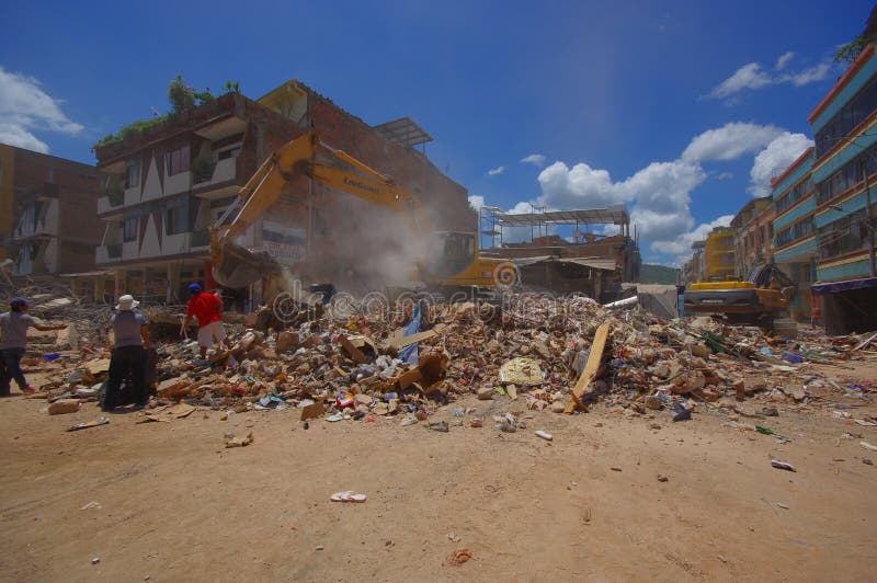 Portoviejo, Ecuador - April, 18, 2016: Building showing the aftereffect of 7.8 earthquake that destroyed the city center, and most of the Manabi province. with heavy machinery.