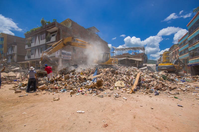 Portoviejo, Ecuador - April, 18, 2016: Building showing the aftereffect of 7.8 earthquake that destroyed the city center, and most of the Manabi province. with heavy machinery.