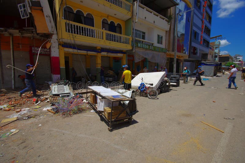 Portoviejo, Ecuador - April, 18, 2016: People gathering their belongings from building showing the aftereffect of 7.8 earthquake that destroyed the city center, and most of the Manabi province. Portoviejo, Ecuador - April, 18, 2016: People gathering their belongings from building showing the aftereffect of 7.8 earthquake that destroyed the city center, and most of the Manabi province.