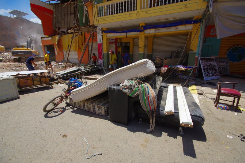 Portoviejo, Ecuador - April, 18, 2016: People gathering their belongings from building showing the aftereffect of 7.8 earthquake that destroyed the city center, and most of the Manabi province. Portoviejo, Ecuador - April, 18, 2016: People gathering their belongings from building showing the aftereffect of 7.8 earthquake that destroyed the city center, and most of the Manabi province.