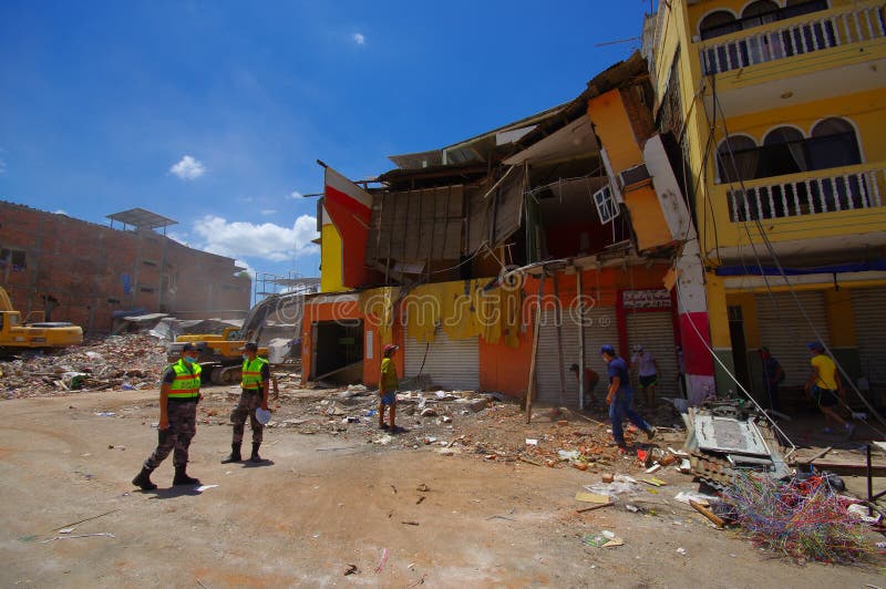 Portoviejo, Ecuador - April, 18, 2016: People gathering their belongings from building showing the aftereffect of 7.8 earthquake that destroyed the city center, and most of the Manabi province. Portoviejo, Ecuador - April, 18, 2016: People gathering their belongings from building showing the aftereffect of 7.8 earthquake that destroyed the city center, and most of the Manabi province.