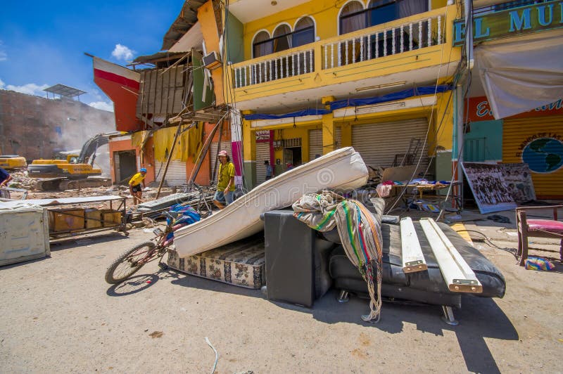 Portoviejo, Ecuador - April, 18, 2016: People gathering their belongings from building showing the aftereffect of 7.8 earthquake that destroyed the city center, and most of the Manabi province. Portoviejo, Ecuador - April, 18, 2016: People gathering their belongings from building showing the aftereffect of 7.8 earthquake that destroyed the city center, and most of the Manabi province.