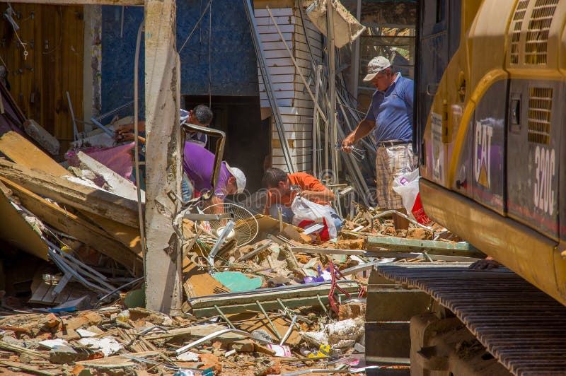 Portoviejo, Ecuador - April, 18, 2016: Building showing the aftereffect of 7.8 earthquake that destroyed the city center, with people looking for their belongings in the rubble.