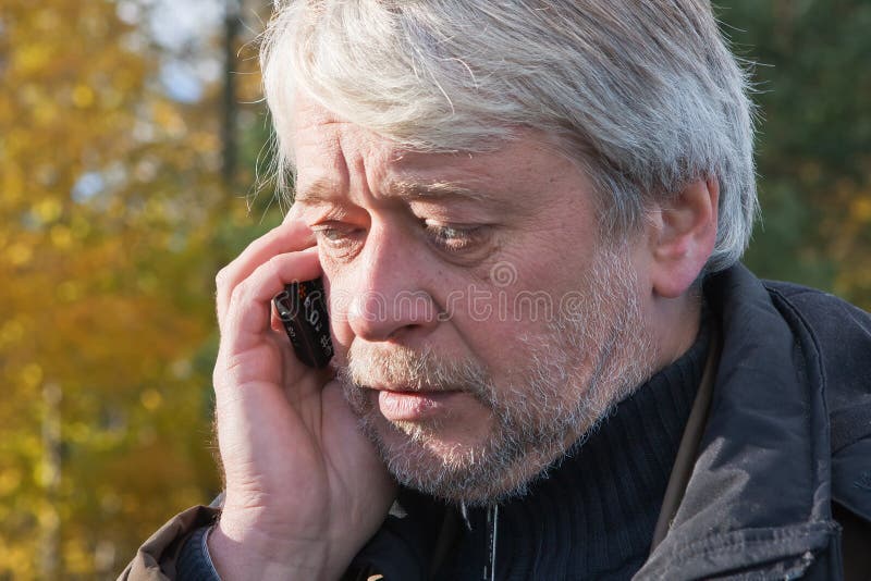 Portrair of mature middle-aged man in forest.