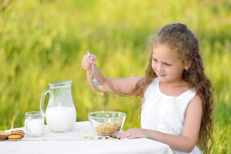 Portrait of Young Girl Having Breakfast and Drinking Milk Outdoor ...