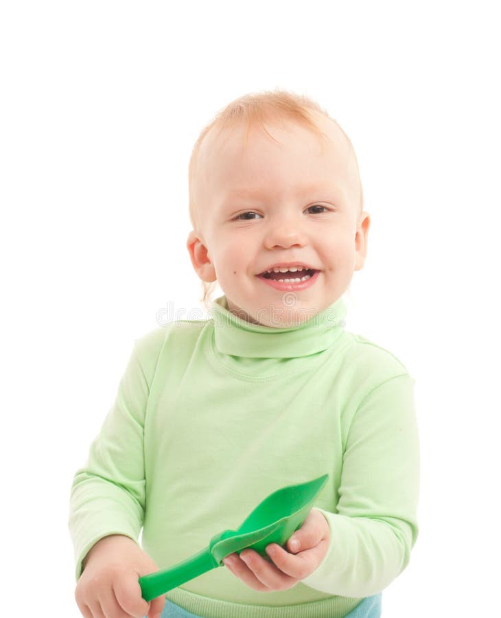 Portrait of adorable joyful boy with toy shovel