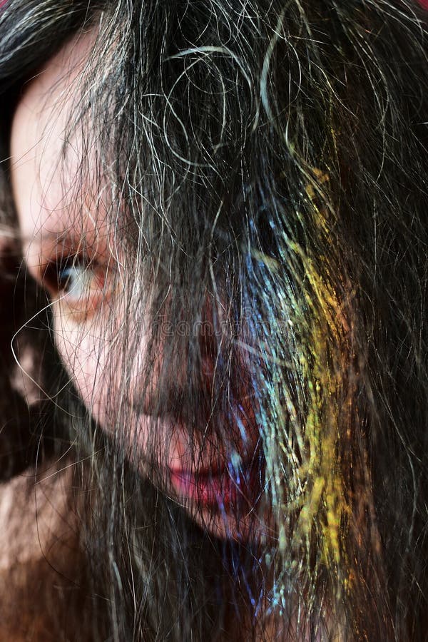 Portrait af une jeune femme avec un arc-en-ciel sur les cheveux foncés photo stock Portrait af une jeune femme avec un arc-en-ciel sur les cheveux foncés photo stock