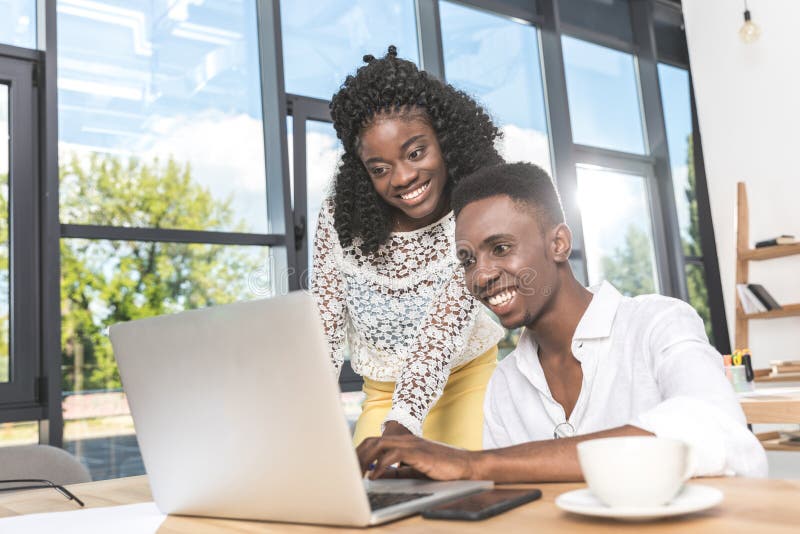 portrait of african american businesspeople working together on laptop stock photo portrait of african american businesspeople working together on laptop stock photo
