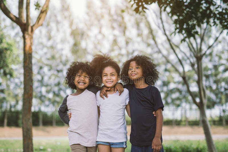 Children Friendship Togetherness Smiling Happiness Concept.Cute african american little boy and girl hug each other in summer sunny day. Children Friendship Togetherness Smiling Happiness Concept.Cute african american little boy and girl hug each other in summer sunny day