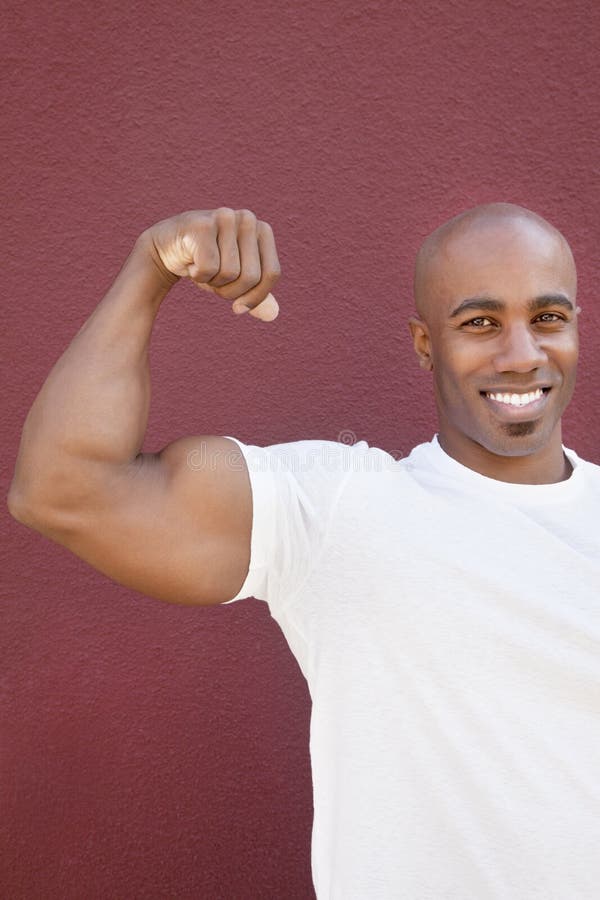 Portrait of an African American male flexing muscles over colored background