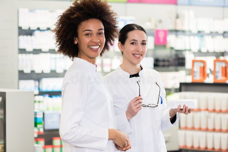 Portrait of a African-American pharmacist next to her colleague