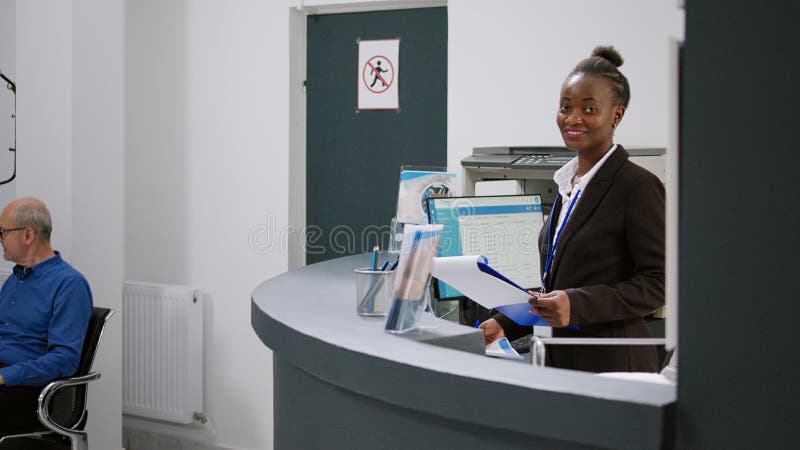 portrait-of-african-american-receptionist-working-at-registration-desk