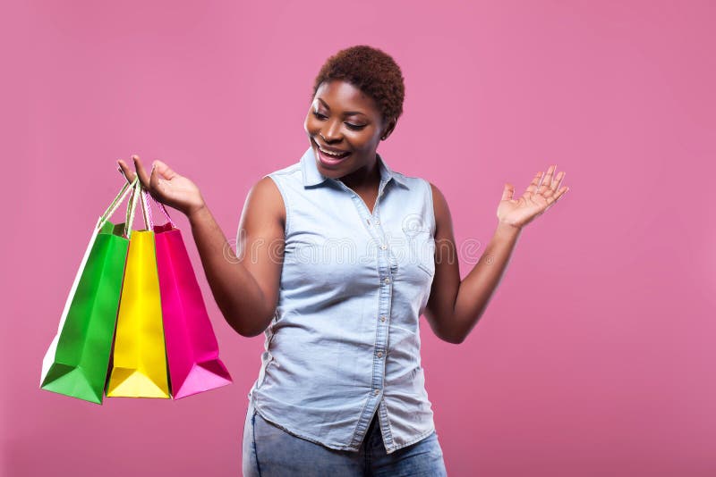 Portrait of African American Woman Carrying Shopping Bags Agains Stock ...