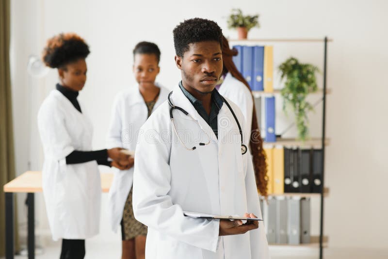 Portrait Of A African Doctor In Front Of His Medical Team Stock Image