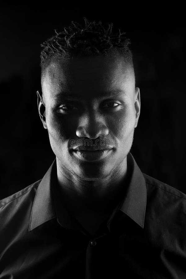 Portrait of a African Man on Black Background, Serious Stock Photo