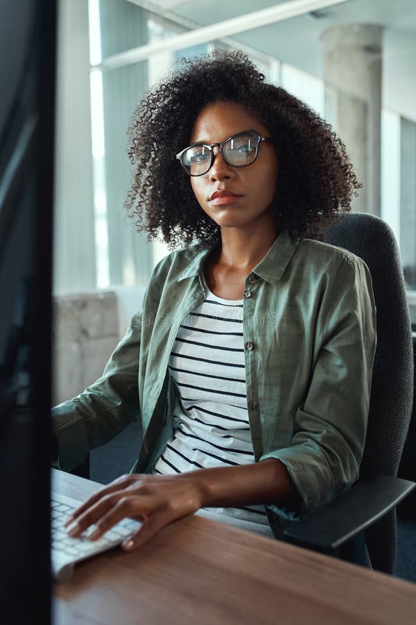 An african young businesswoman looking at camera stock photos An african young businesswoman looking at camera stock photos