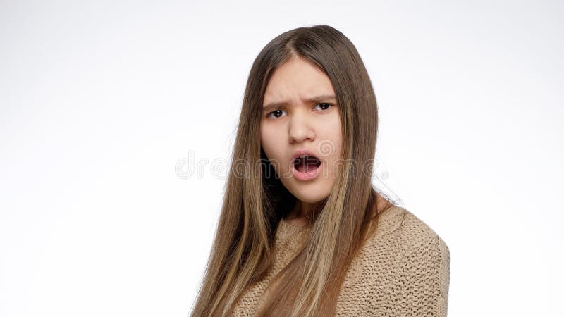 Portrait of amazed or shocked girl opens mouth over white background