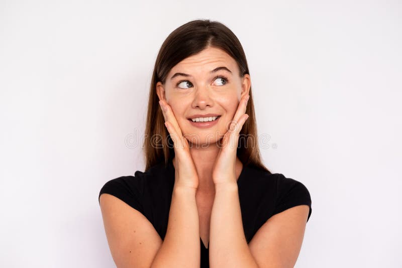 Portrait of Amazed Young Woman Looking Away Touching Face Stock Photo ...