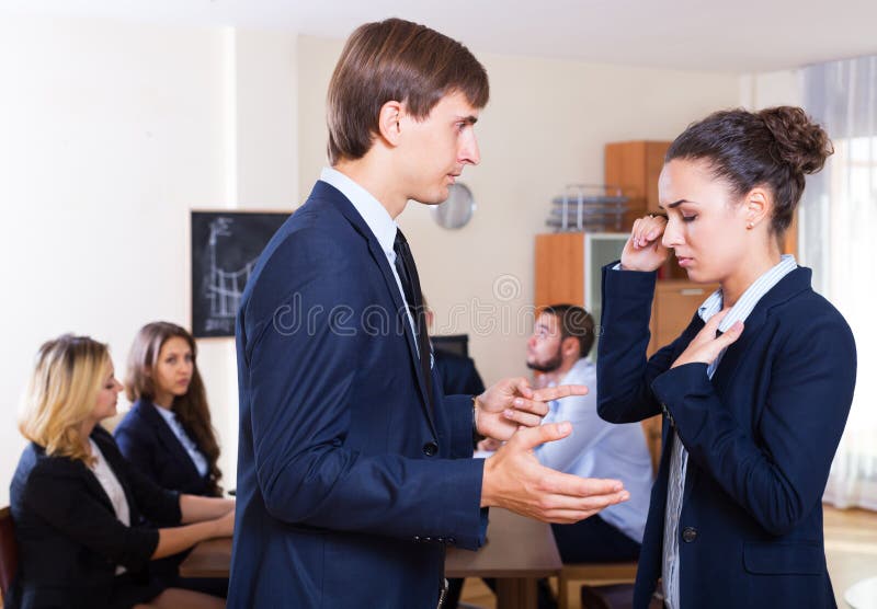 Portrait of angry boss and upset employee in the office interior