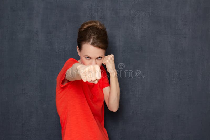 Portrait Of Angry Furious Young Woman Holding Fists Clenched Stock