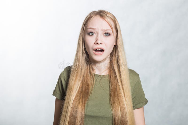 Portrait of angry screaming young woman on the gray background. stock image Portrait of angry screaming young woman on the gray background. stock image