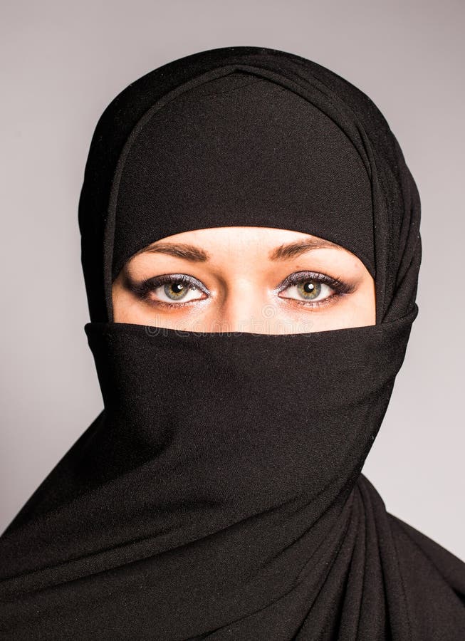 Portrait Of An Arabic Young Woman With Her Beautiful Blue Eyes In Traditional Islamic Cloth