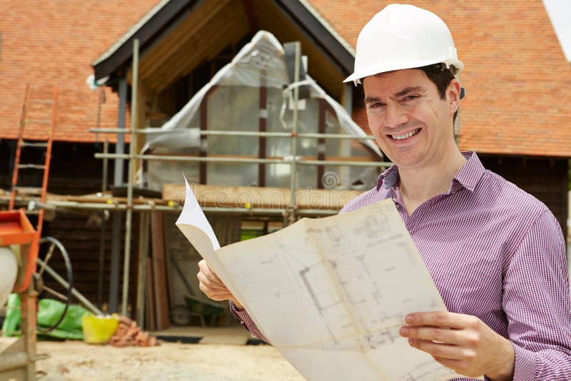 Portrait Of Architect On Building Site Looking At House Plans royalty free stock images Portrait Of Architect On Building Site Looking At House Plans royalty free stock images