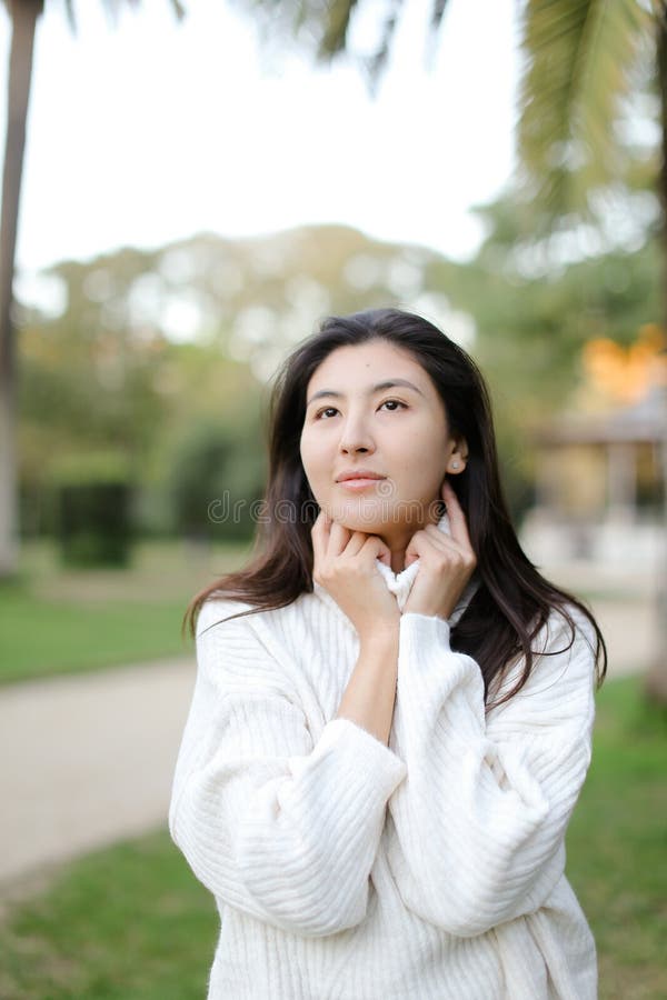 Asian Girl In Tropical Park Talking By Smartphone Near Palm Stock