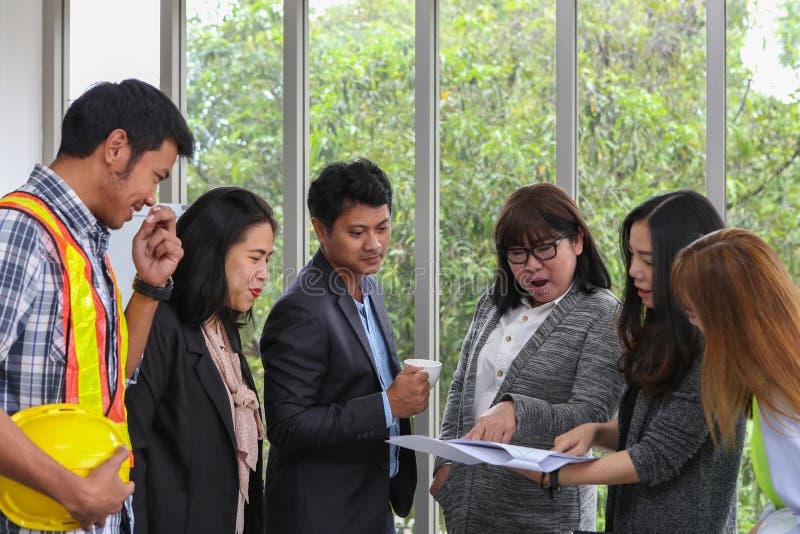 Portrait of Asian Engineer. Young architectural team at work. Office worker viewing document in meeting room. Engineer and stock photos