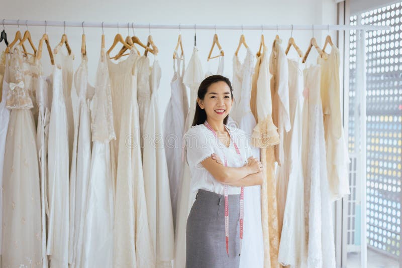 Portrait of asian woman wedding dress store owner,Beautiful dressmaker in shop and small business