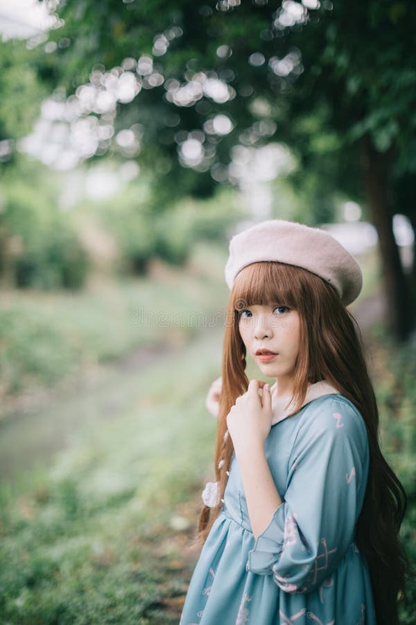 Portrait of Asian Girl in Lolita Fashion Dress in Garden Stock Photo ...
