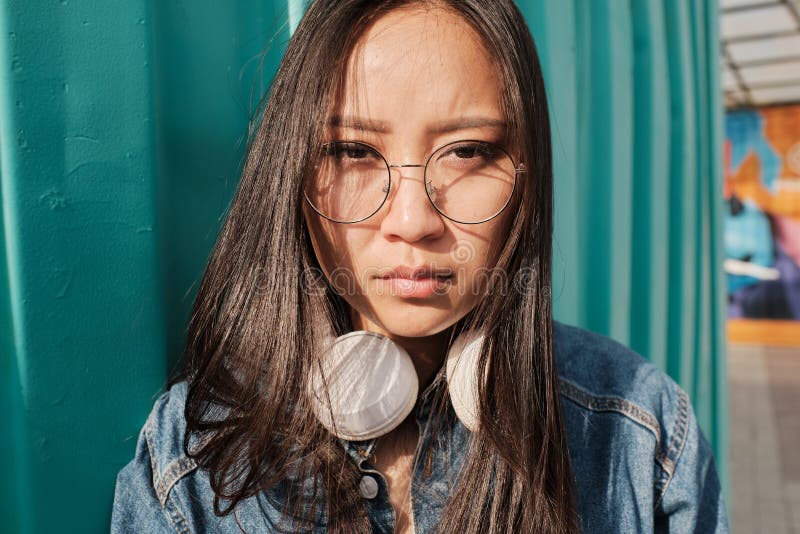 Portrait Of An Asian Girl Wearing Glasses And Headphones Stock Image Image Of Cyan Girly