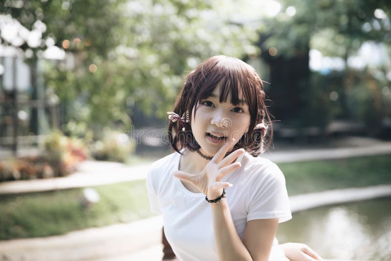 Portrait of asian girl with white shirt looking in outdoor nature vintage film style.