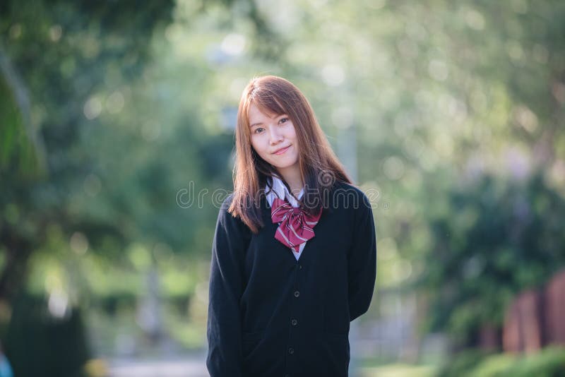 Portrait of asian japanese school girl costume at outdoor park. Close, lifestyle.