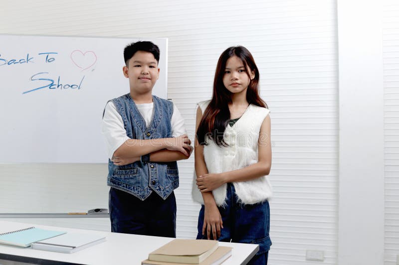 Portrait of Asian schoolgirl and schoolboy student standing in classes. Elementary school children engage in study at school. stock image