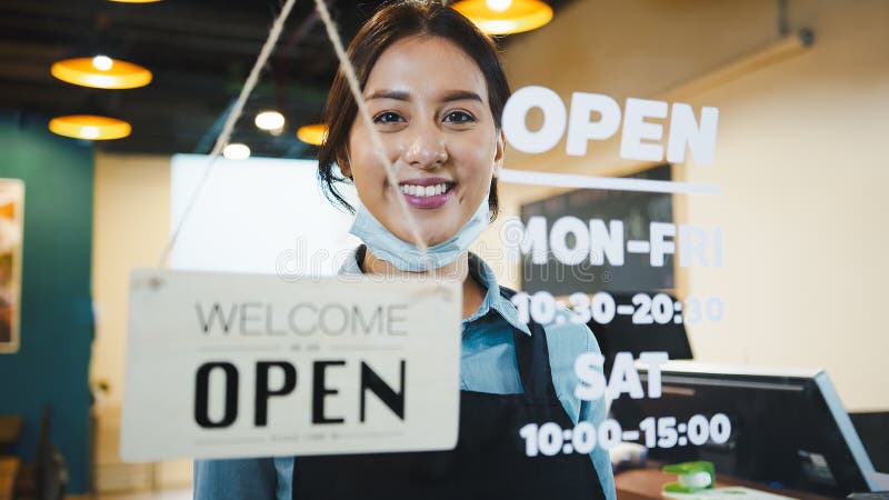 Portrait of Asian woman restaurant or coffee shop owner smile, hanging open sign post stock image