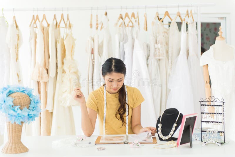 Portrait of asian woman wedding dress store owner,Beautiful female dressmaker in shop and small business