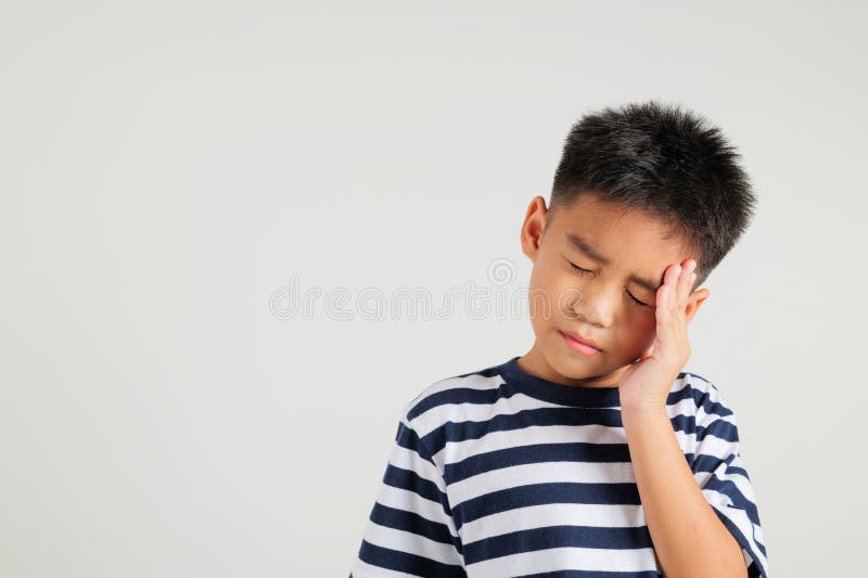 Portrait of Asian young kid boy sad tired strain face holding hold head by hands royalty free stock photos