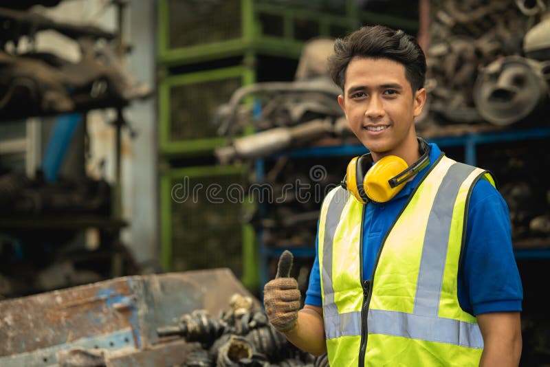 Portrait Asian young male engineer staff worker foreman work in heavy industry happy smiling royalty free stock photography