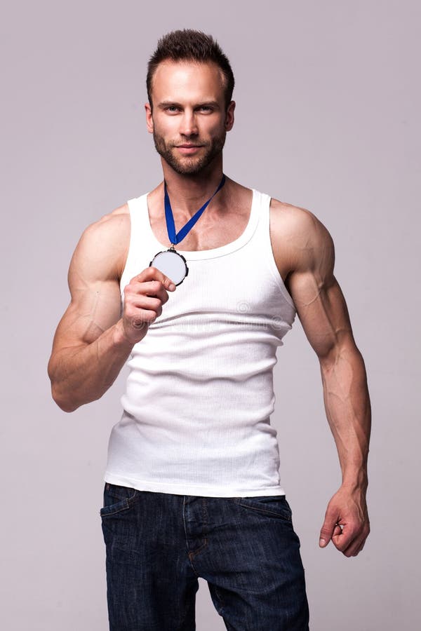 Portrait of athletic man in white undershirt with champions medal royalty free stock image Portrait of athletic man in white undershirt with champions medal royalty free stock image