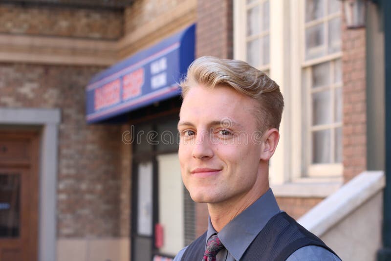 Portrait of attractive businessman on urban background / Closeup of young interesting businessman