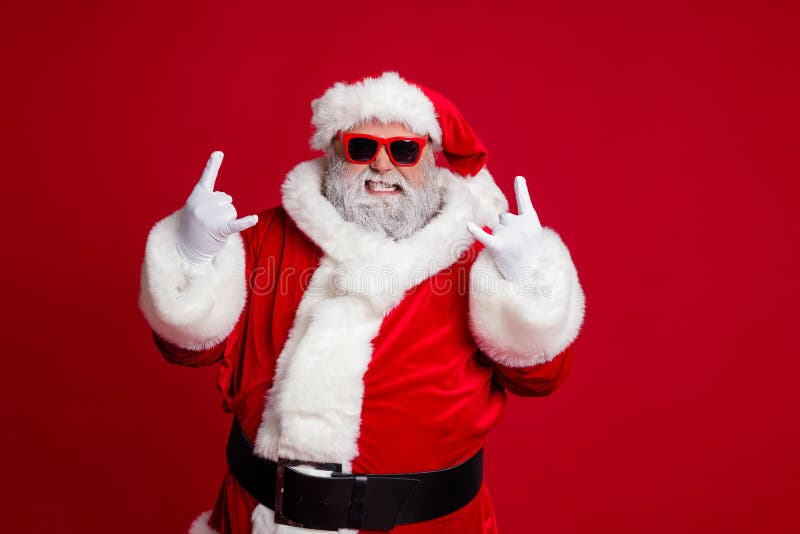 Portrait of attractive crazy Santa showing horn symbol having fun newyear occasion isolated over bright red color